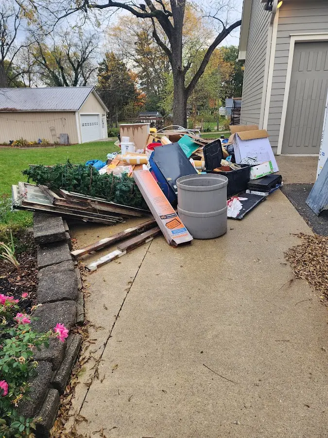 Dumpster being loaded with debris for 12 Yard Dumpster Rental in Elsmere